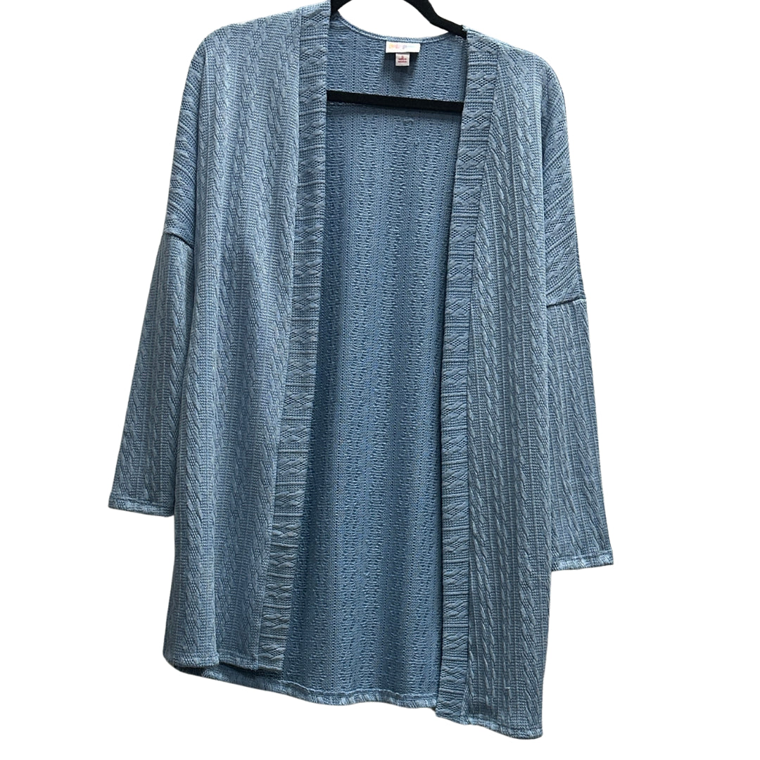 LuLaRoe Connie Lightweight Overlay in Solid Denim Blue featuring a lightweight cable knit texture, open front cardigan, relaxed fit, and long sleeves layered over a white ribbed tank.