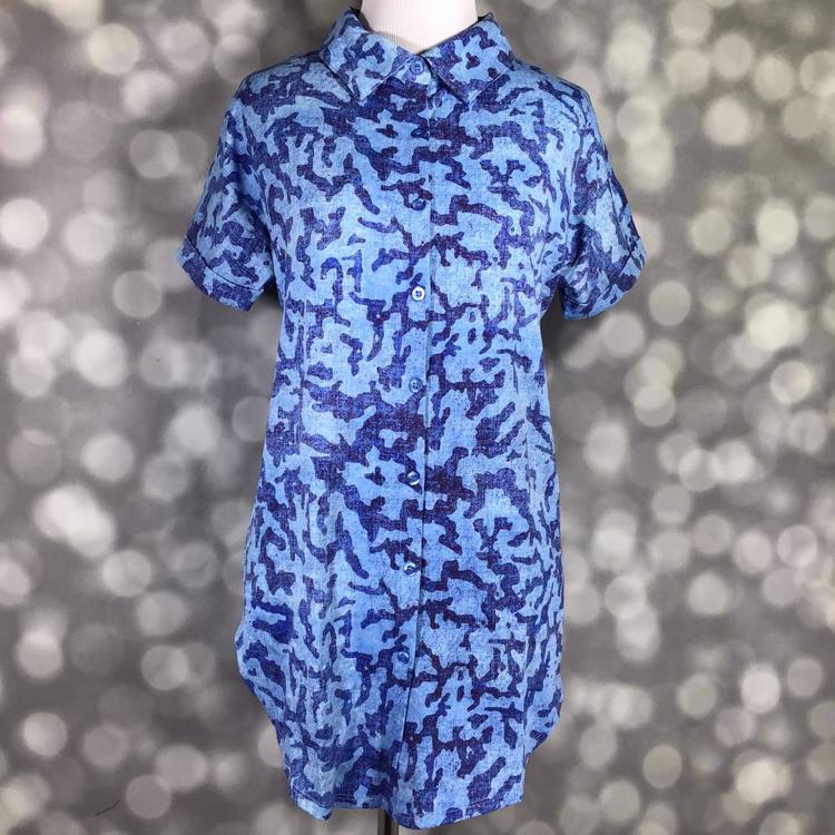 Front view of mannequin wearing LuLaRoe Charlie Button Up Shirt in blue abstract pattern with short sleeves and button front