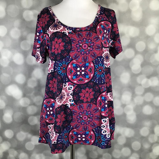 Front view of LuLaRoe Classic T on mannequin in vibrant magenta and blue mandala pattern with short sleeves and a relaxed curved hemline