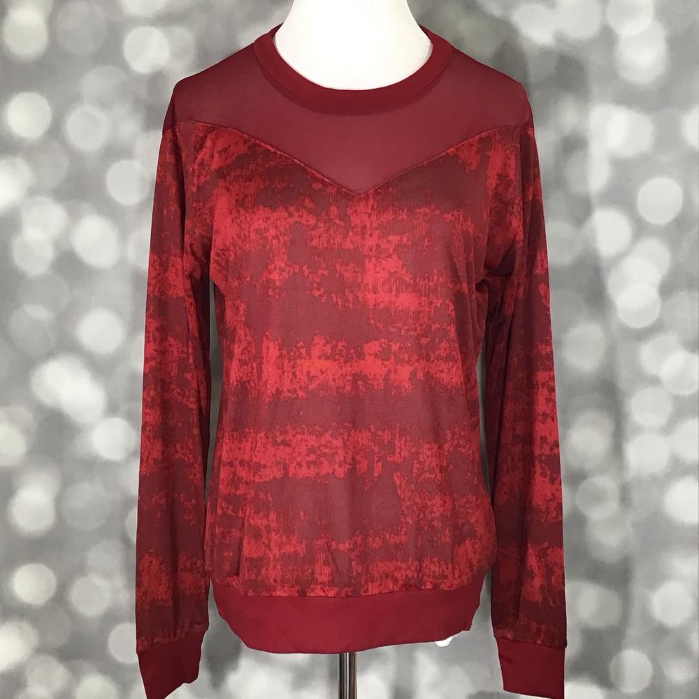 LuLaRoe Lizzy Sweater in textured crimson red with matching mesh yoke, ribbed trim, and lightweight sweater knit fabric on a mannequin against a blurred gray background