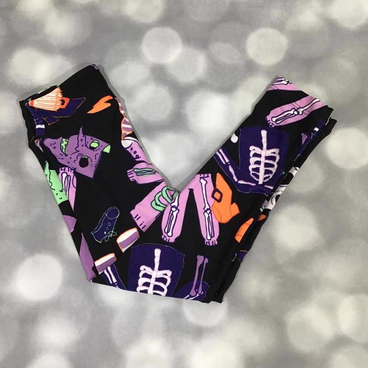 LuLaRoe Halloween leggings in black with neon skeleton bones and spooky details in purple, orange, and green