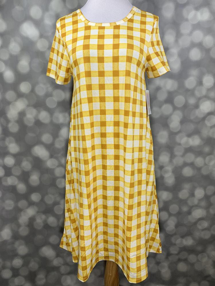 Front view of LuLaRoe Jessie dress on mannequin featuring golden yellow and white gingham pattern, short sleeves, and flowy swing fit on a blurred background