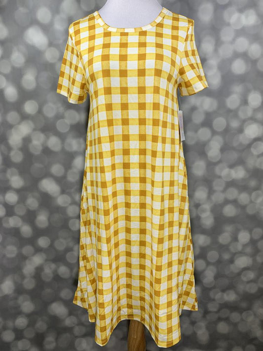 Front view of LuLaRoe Jessie dress on mannequin featuring golden yellow and white gingham pattern, short sleeves, and flowy swing fit on a blurred background