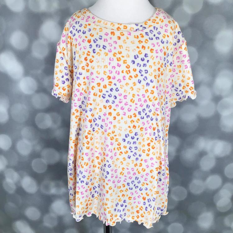 LuLaRoe Kids Lacey Top in cream with yellow, pink, and purple cheetah print and lettuce-edge trim