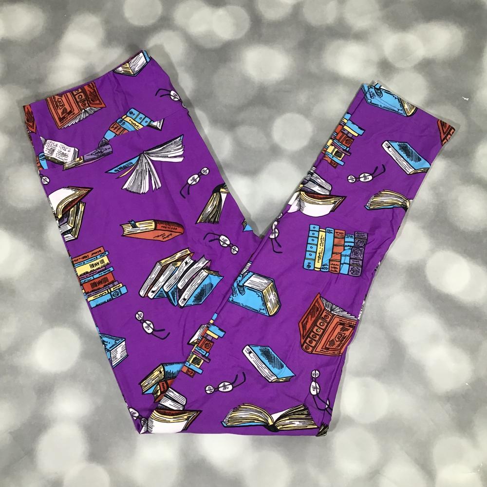 Purple leggings with book pattern on a gray background