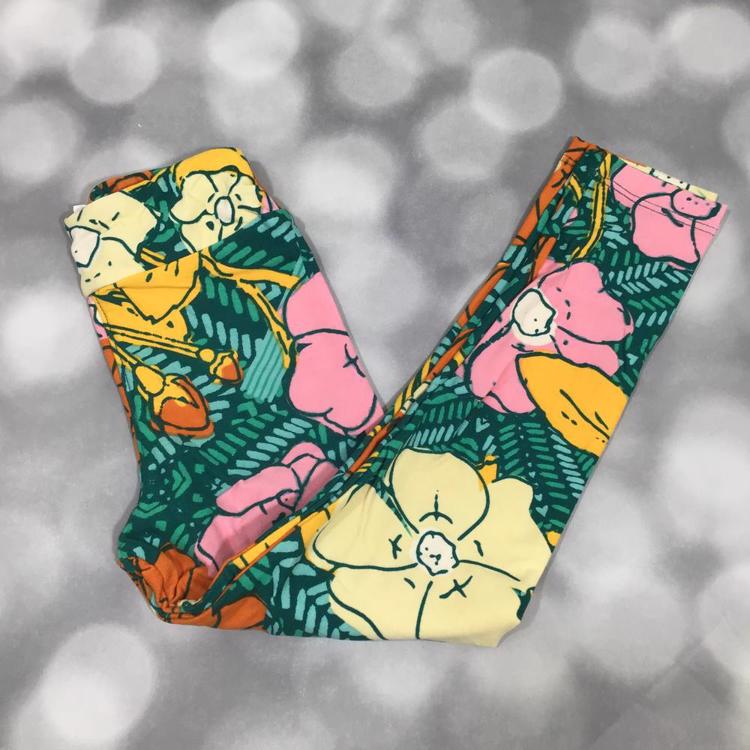 LuLaRoe leggings in Tropical Bloom with bold yellow, pink, and ivory oversized flowers on a green background.