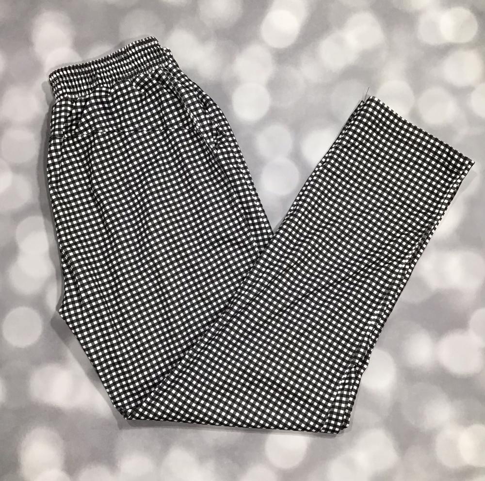 Black and white checkered pants on a blurred gray background