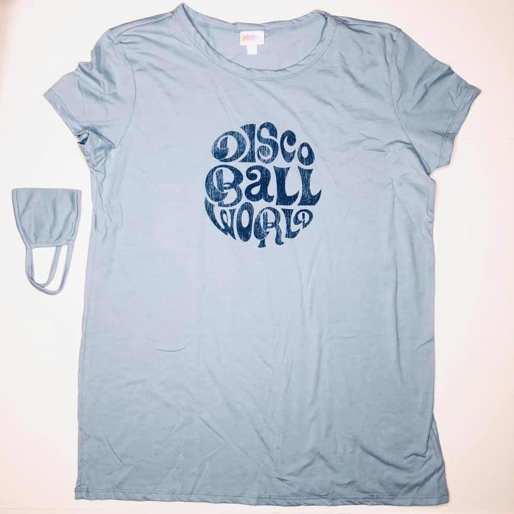 LuLaRoe Liv Tee light blue graphic shirt featuring navy retro lettering that reads “Disco Ball World” inside a circular vintage-style design.