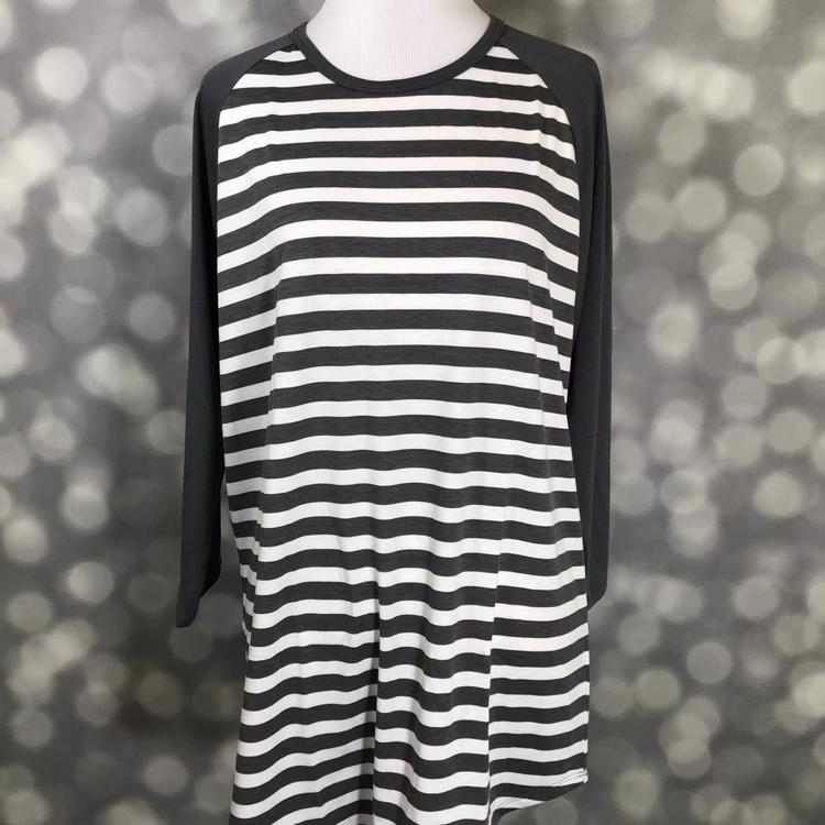 LuLaRoe Randy Tee with black and white striped body and solid black long sleeves on a mannequin with a blurred gray background