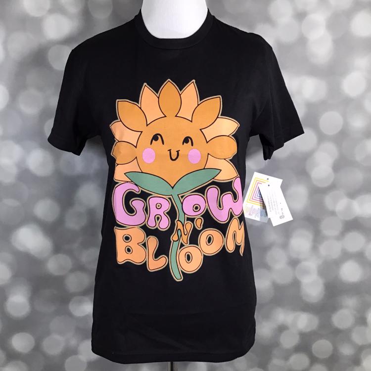 LuLaRoe Rocker T in black with “Grow N’ Bloom” sunflower graphic, retro lettering, and positive message.