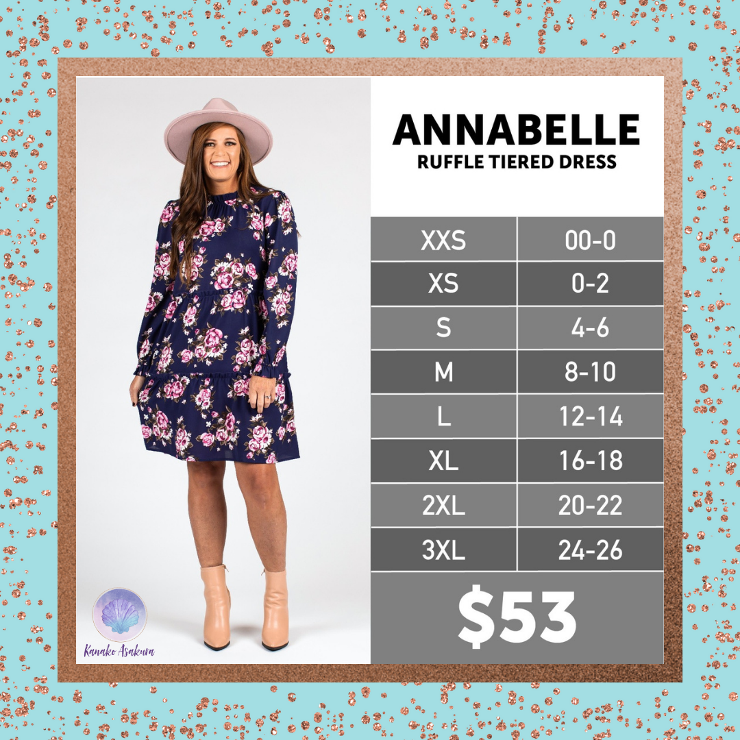 A smiling woman in a pink hat wears a long-sleeve navy dress with pink floral print. Next to her is a size chart for the Annabelle ruffle tiered dress and its price, $53, on a sparkly blue and copper background.