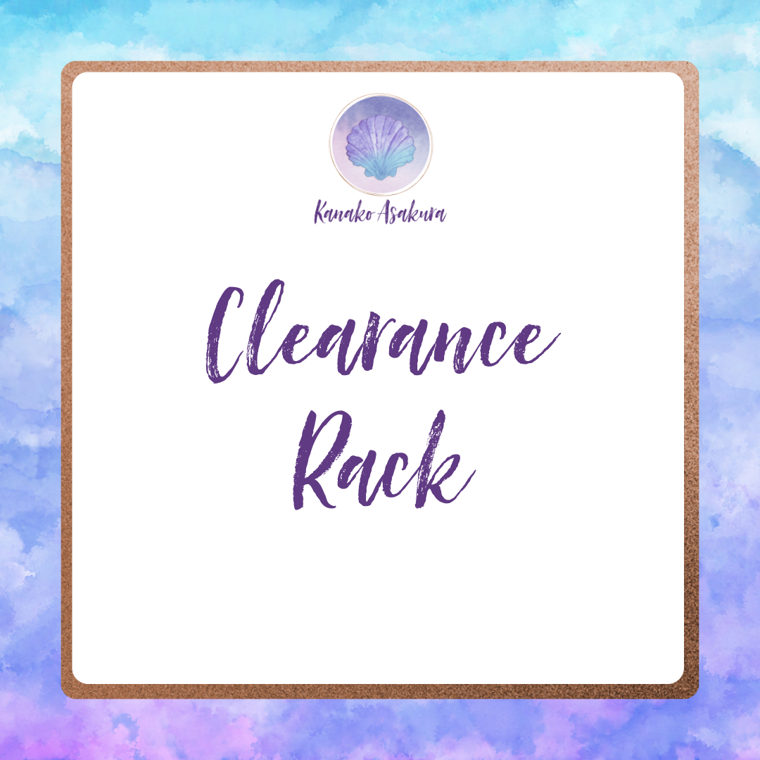 A white square sign with a rose gold border and watercolor blue background reads Clearance Rack in large purple script. Above is a seashell logo and Kanako Ashikawa in cursive.