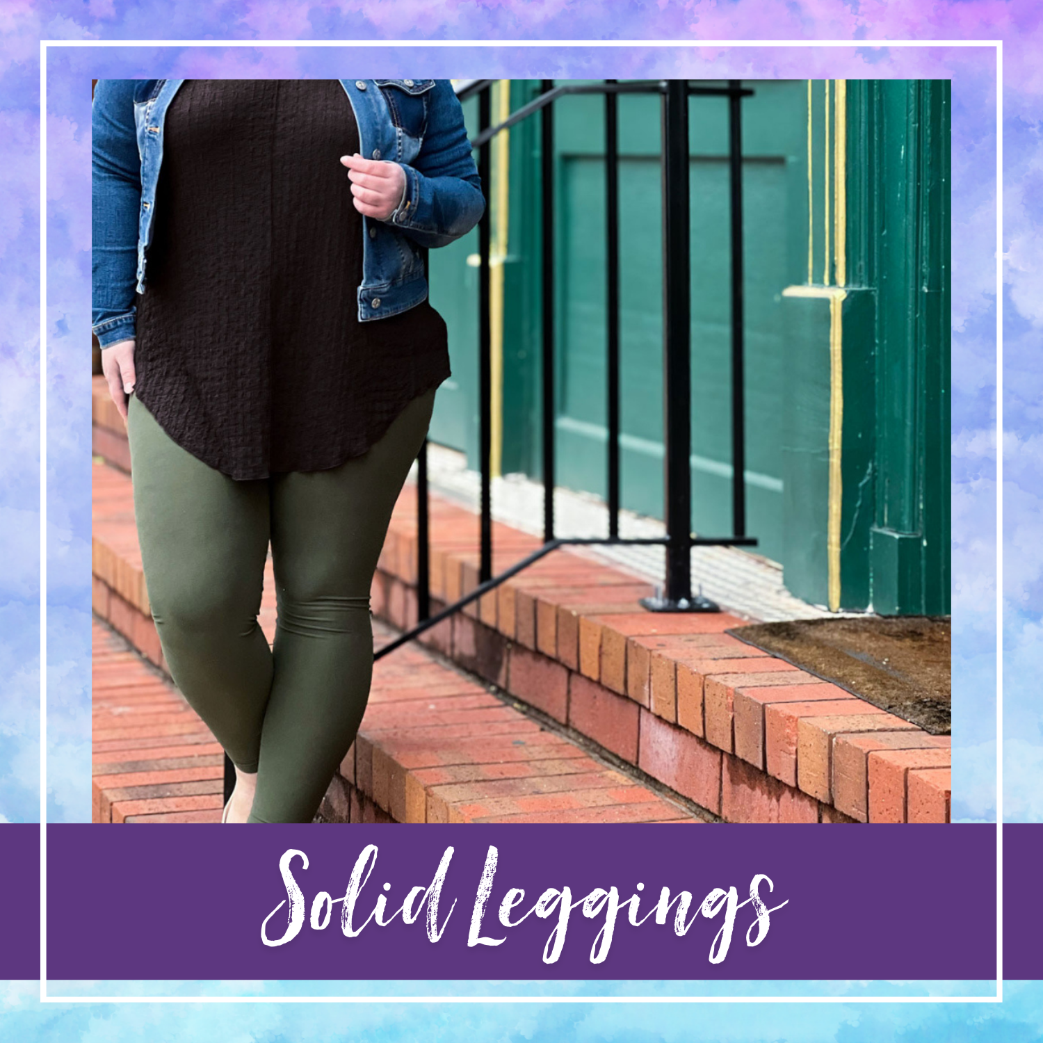 Woman wearing olive green LuLaRoe solid leggings with a black tunic and denim jacket, standing on brick steps with a green and yellow building background.