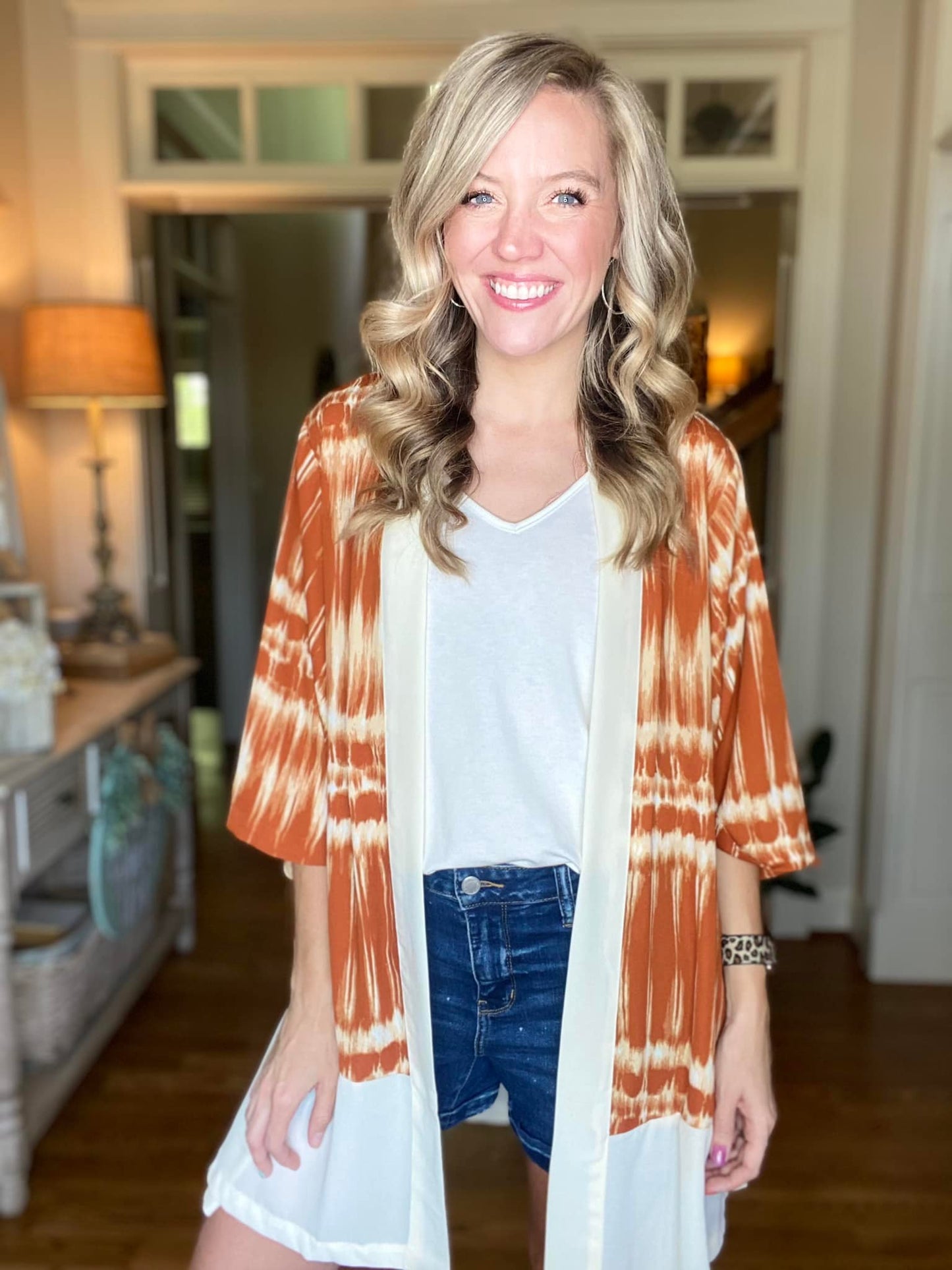 LuLaRoe Aurora bell sleeve kimono in a rust and ivory tie-dye stripe print with solid ivory trim