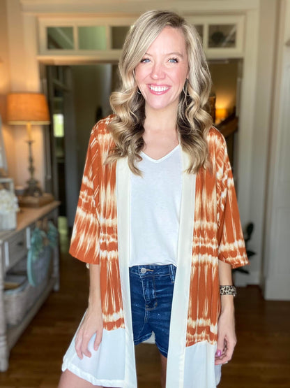 LuLaRoe Aurora bell sleeve kimono in a rust and ivory tie-dye stripe print with solid ivory trim