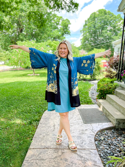 LuLaRoe Aurora bell sleeve kimono in a teal, yellow and black botanical floral print