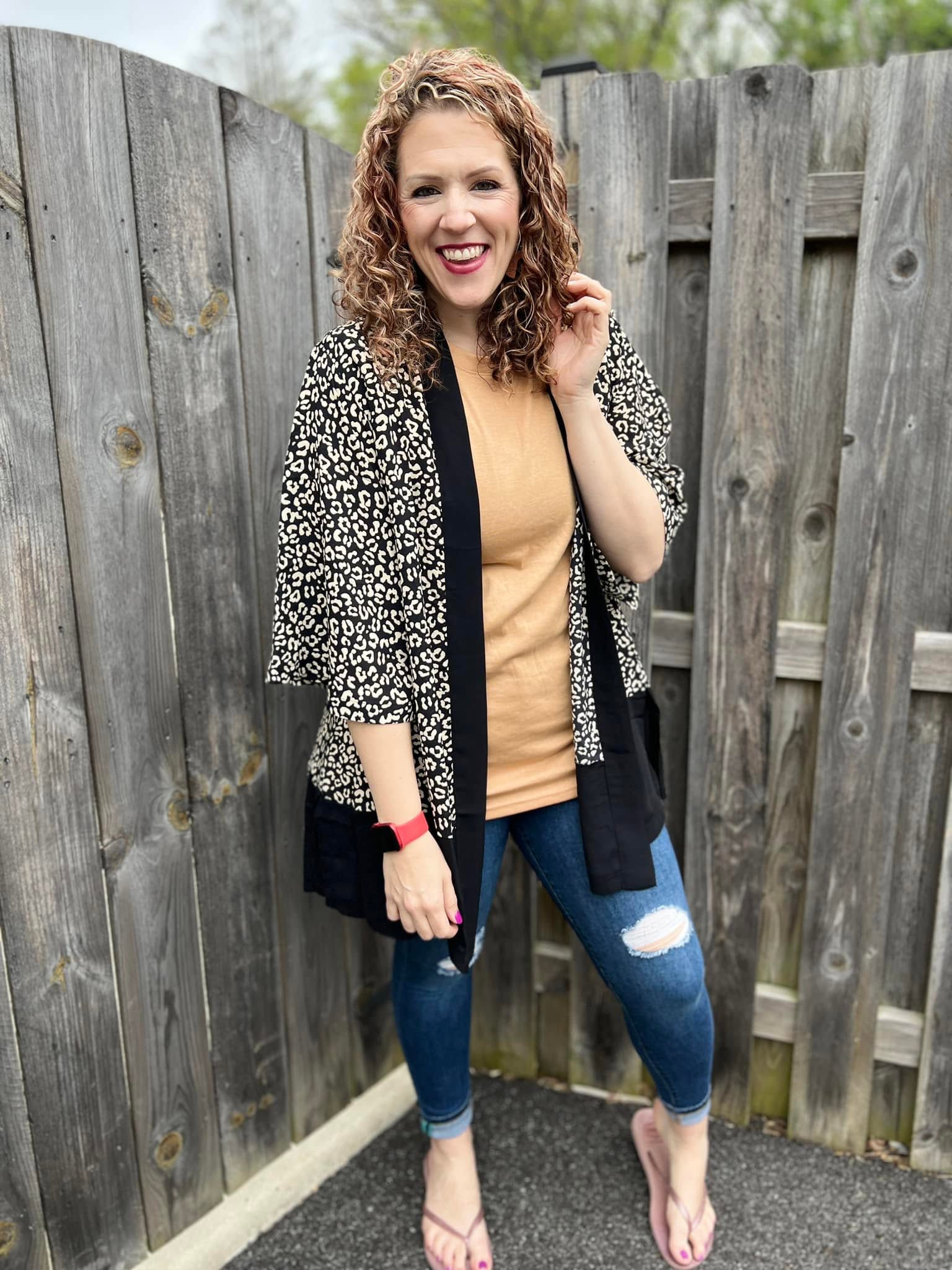 LuLaRoe Aurora bell sleeve kimono in a black and ivory leopard print with solid black trim