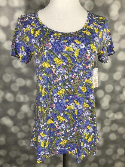 LuLaRoe Classic T periwinkle blue yellow wildflowers geometric triangles print on a short sleeve scoop neck relaxed A-line tee