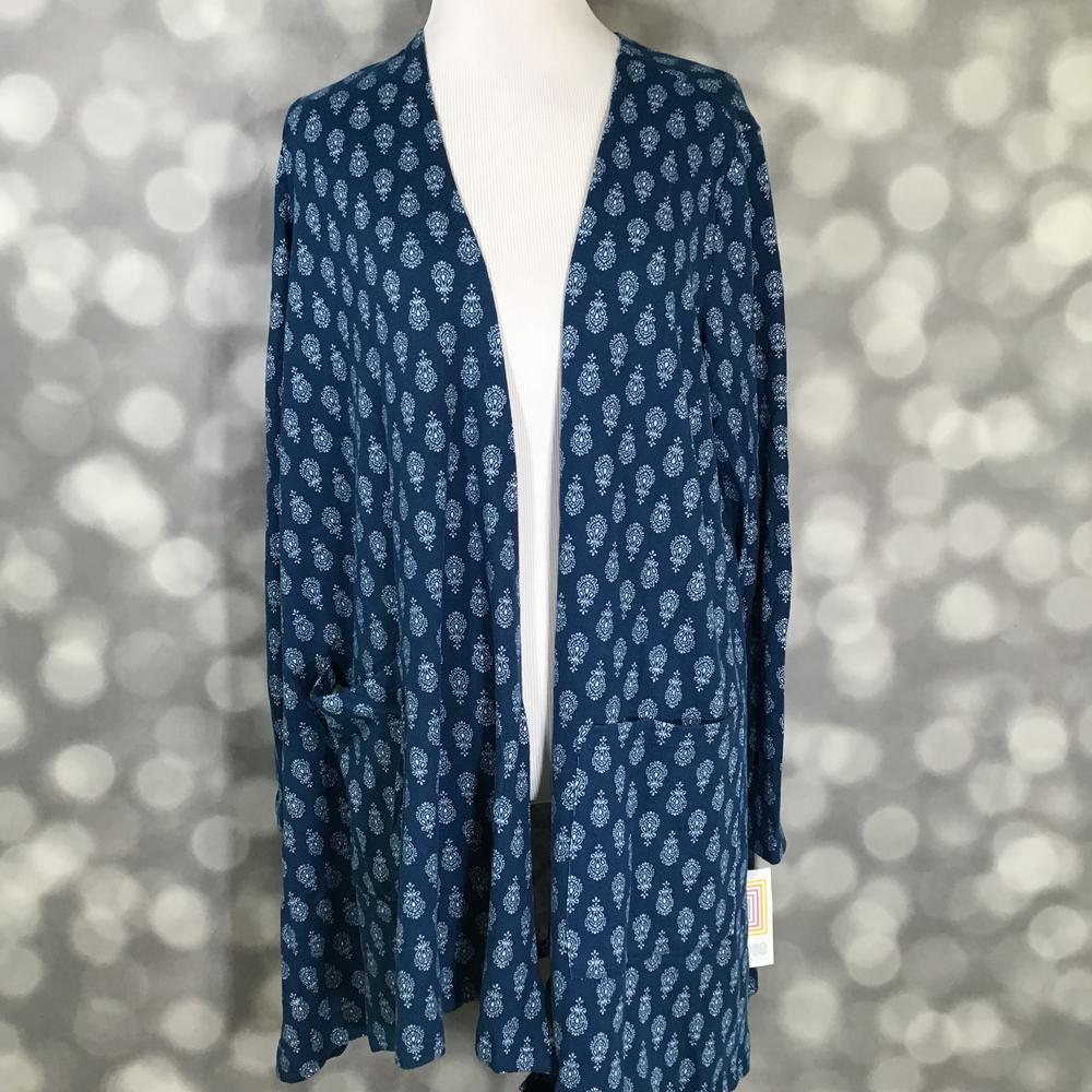 LuLaRoe Caroline Cardigan in Indigo Paisley Medallion featuring a navy blue background with white paisley-inspired medallion print, open front design, long sleeves, and front pockets.