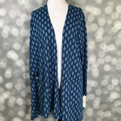 LuLaRoe Caroline Cardigan in Indigo Paisley Medallion featuring a navy blue background with white paisley-inspired medallion print, open front design, long sleeves, and front pockets.