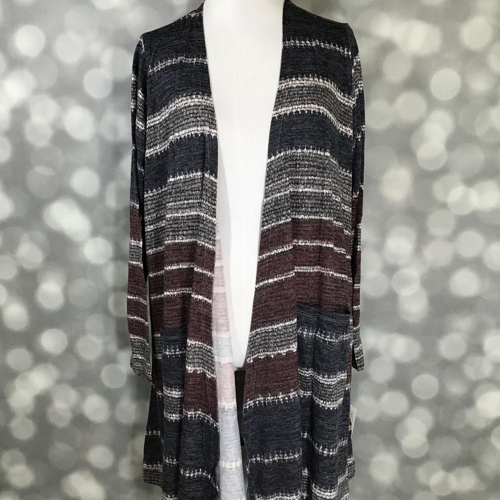LuLaRoe Caroline Cardigan in Rustic Canyon Stripe featuring heathered charcoal, brown, ivory, and gray horizontal stripes with an open front, long sleeves, and front pockets.