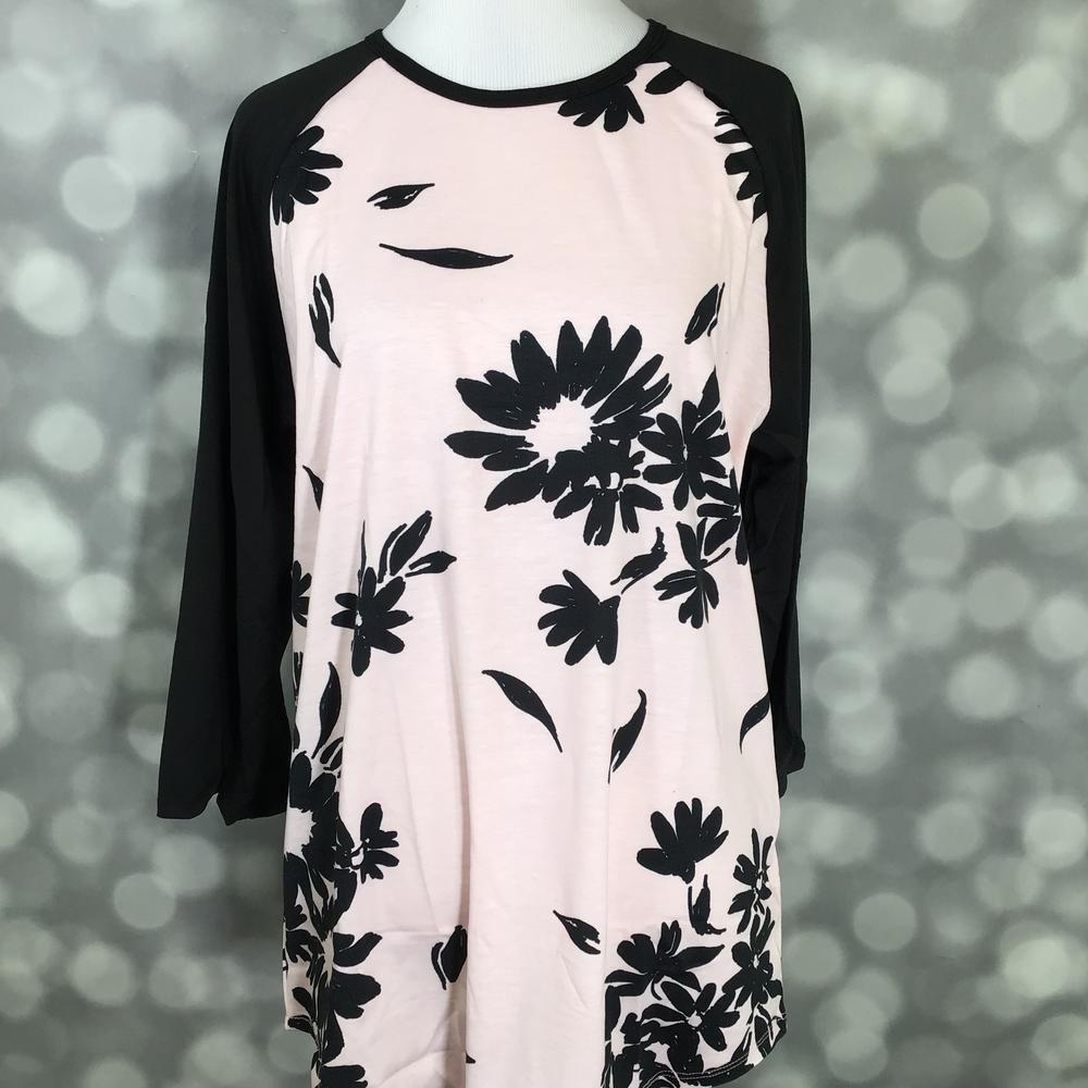 LuLaRoe Randy Tee in Blush Midnight Bloom featuring oversized black floral silhouettes on a soft blush pink background with black 3/4 raglan sleeves in size Large.