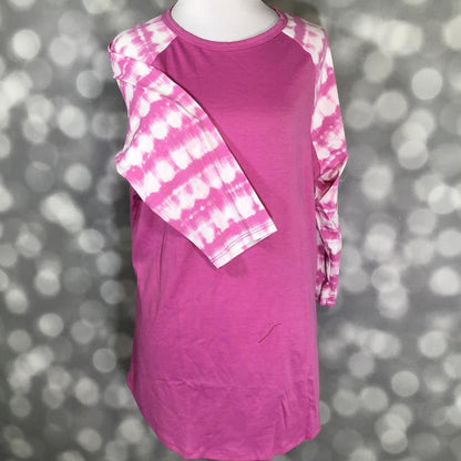 LuLaRoe Randy Tee in Berry Sunset Tie Dye featuring a vibrant berry pink body with pink and ivory shibori-inspired tie-dye raglan sleeves in size Large.