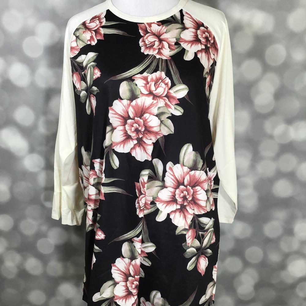 LuLaRoe Randy Tee in Midnight Blush Magnolia featuring oversized blush pink magnolia flowers on a black background with ivory 3/4 raglan sleeves in size XL.