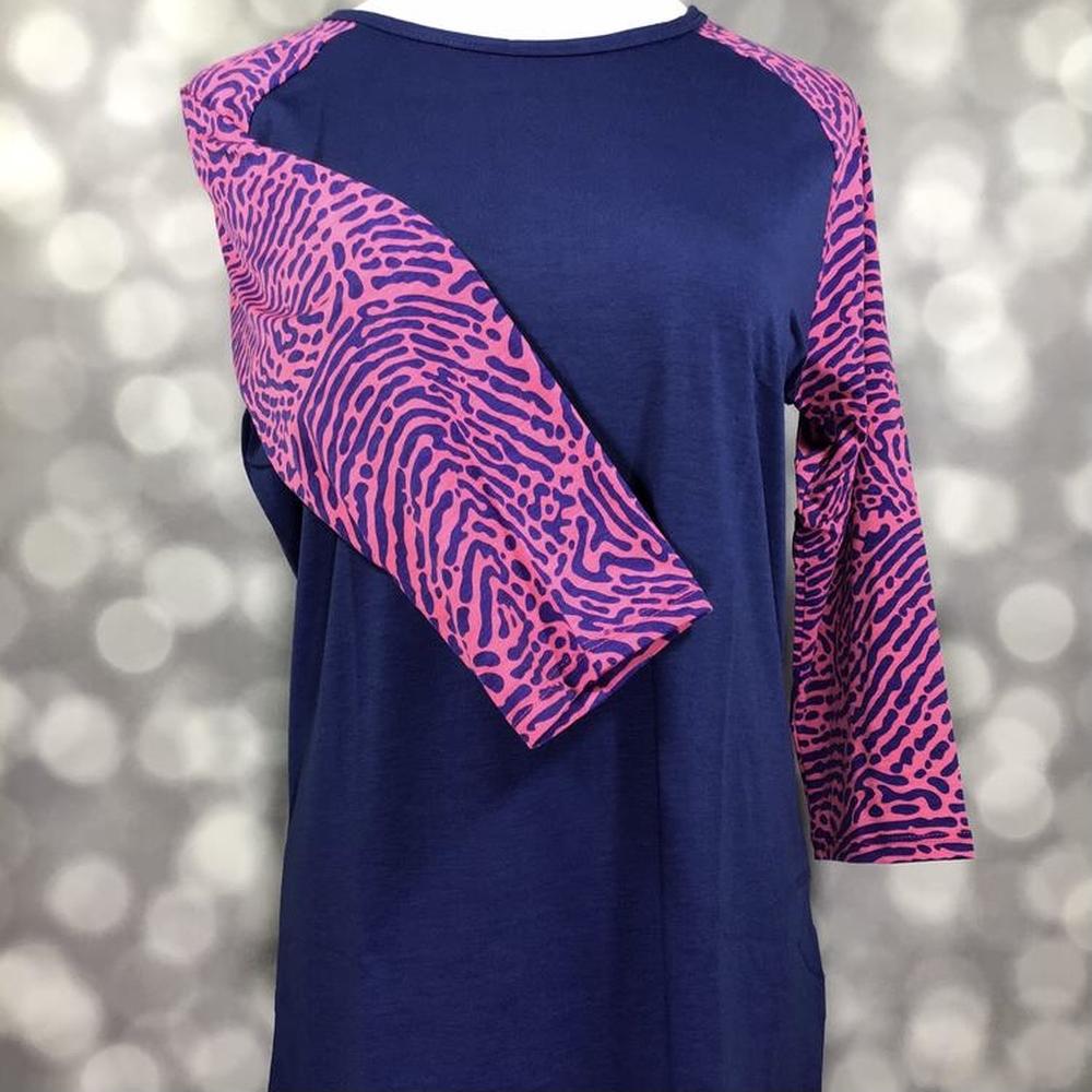 LuLaRoe Randy Tee in Electric Safari featuring a deep navy body with magenta abstract animal print raglan sleeves in size XL.