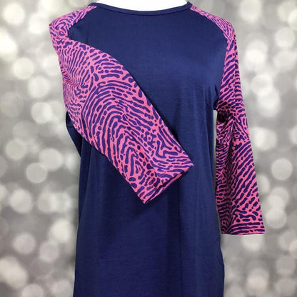 LuLaRoe Randy Tee in Electric Safari featuring a deep navy body with magenta abstract animal print raglan sleeves in size XL.