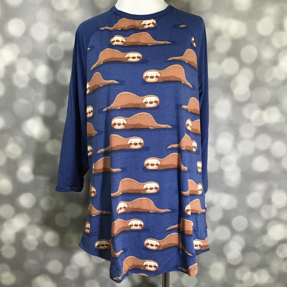 LuLaRoe Randy Tee in Sleepy Sloths featuring an all-over lounging sloth print on a cobalt blue background with matching blue 3/4 raglan sleeves in size XL.