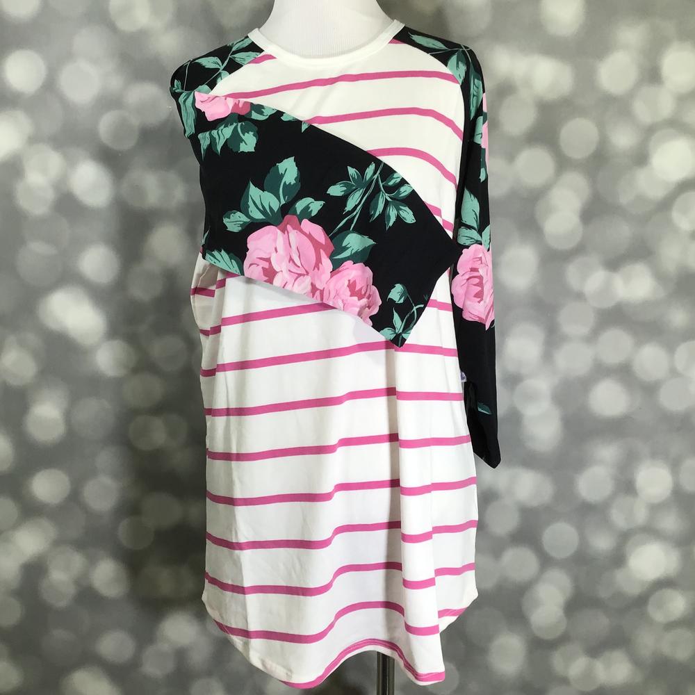 LuLaRoe Randy Tee in Garden Party Stripe featuring an ivory body with raspberry pink stripes and black raglan sleeves printed with blush pink roses and sage green leaves in size Large.