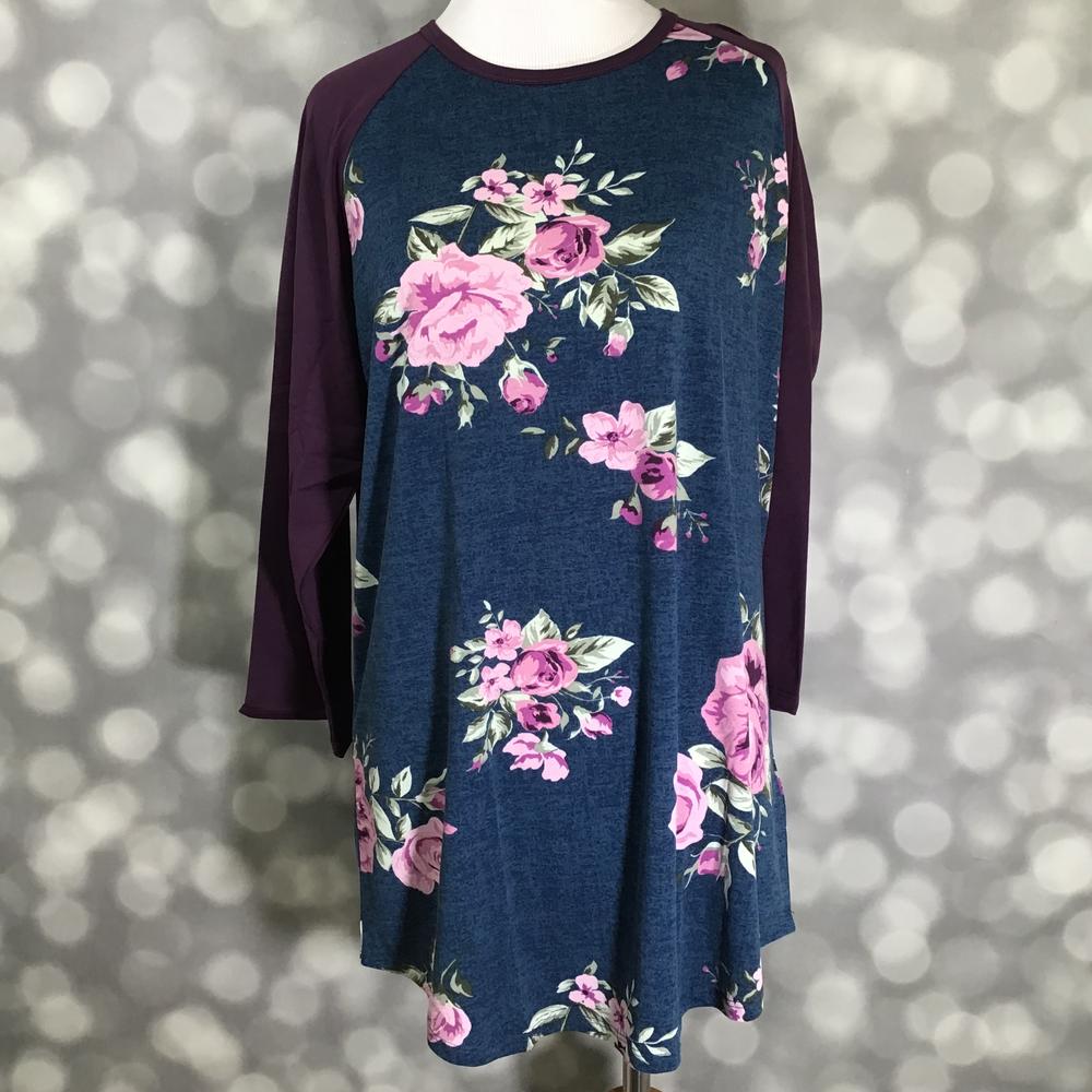 LuLaRoe Randy Tee in Plum Rose Bouquet featuring pink and mauve rose bouquets on a heathered navy background with rich plum 3/4 raglan sleeves in size XL.