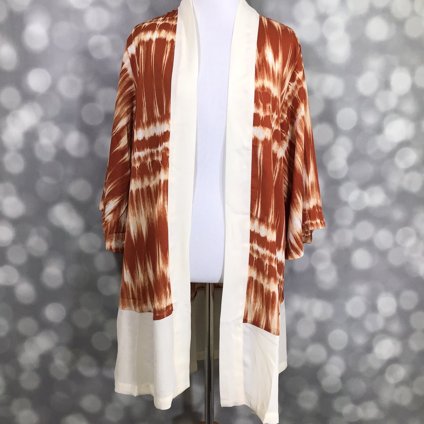 LuLaRoe Aurora bell sleeve kimono in a rust and ivory tie-dye stripe print with solid ivory trim