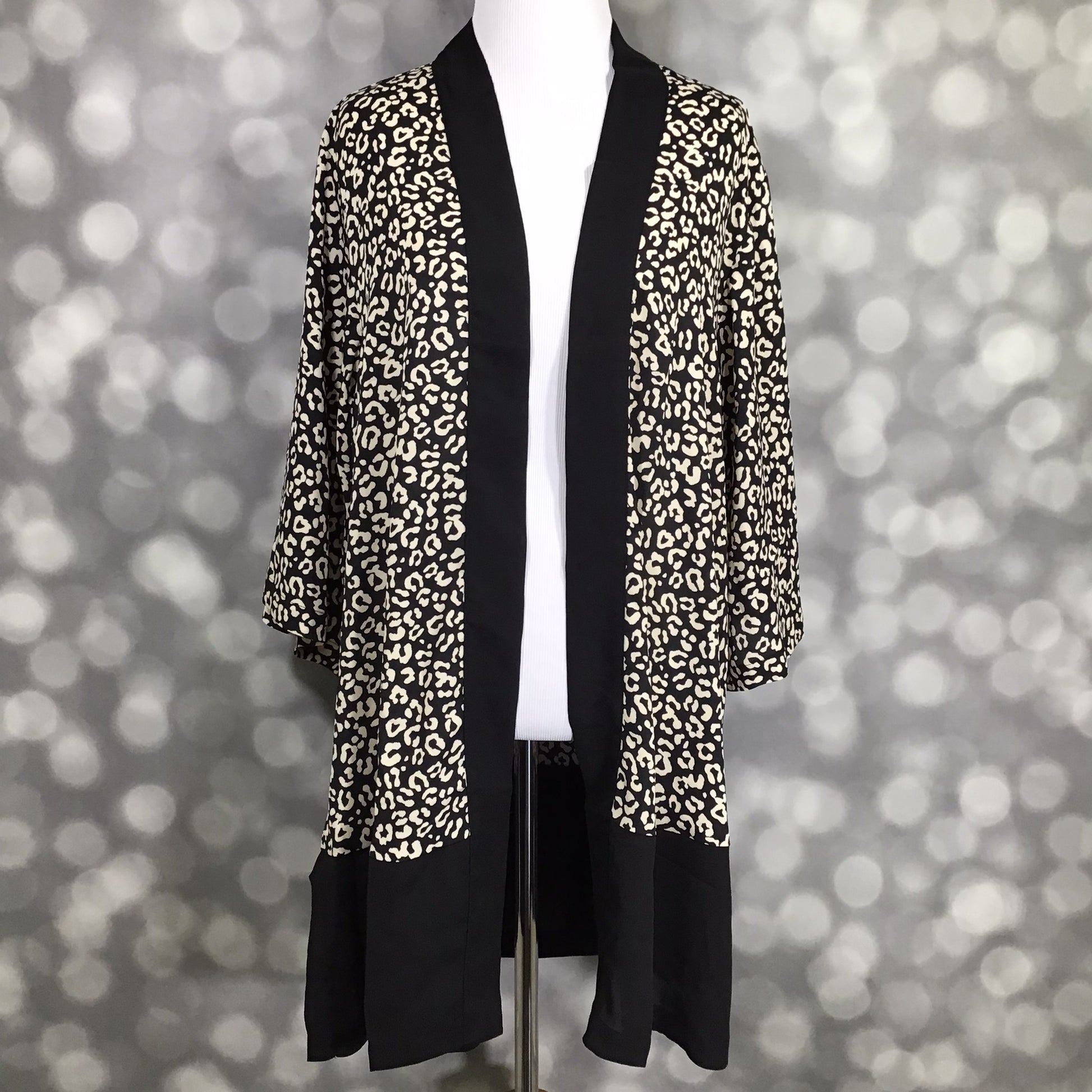LuLaRoe Aurora bell sleeve kimono in a black and ivory leopard print with solid black trim