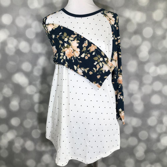 LuLaRoe Randy Tee in Midnight Rose Garden featuring an ivory body with black polka dots and navy raglan sleeves with blush and ivory floral prints in size Medium.