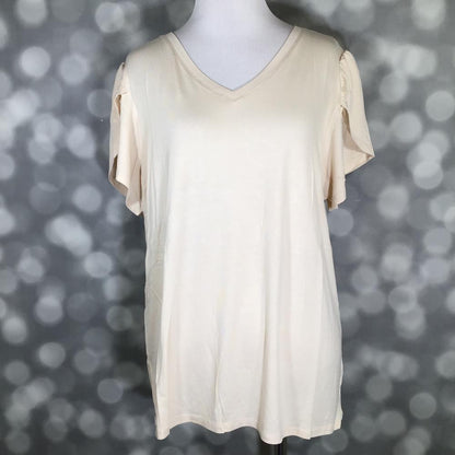Soft cream LuLaRoe Remi top with V-neck and tulip sleeves, displayed on mannequin against a blurred gray background
