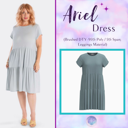 Woman wearing LuLaRoe Ariel Tiered Dress in Solid Misty Sage, a soft gray-green tiered short dress with relaxed fit, flowy silhouette, and comfortable stretch fabric for everyday style.