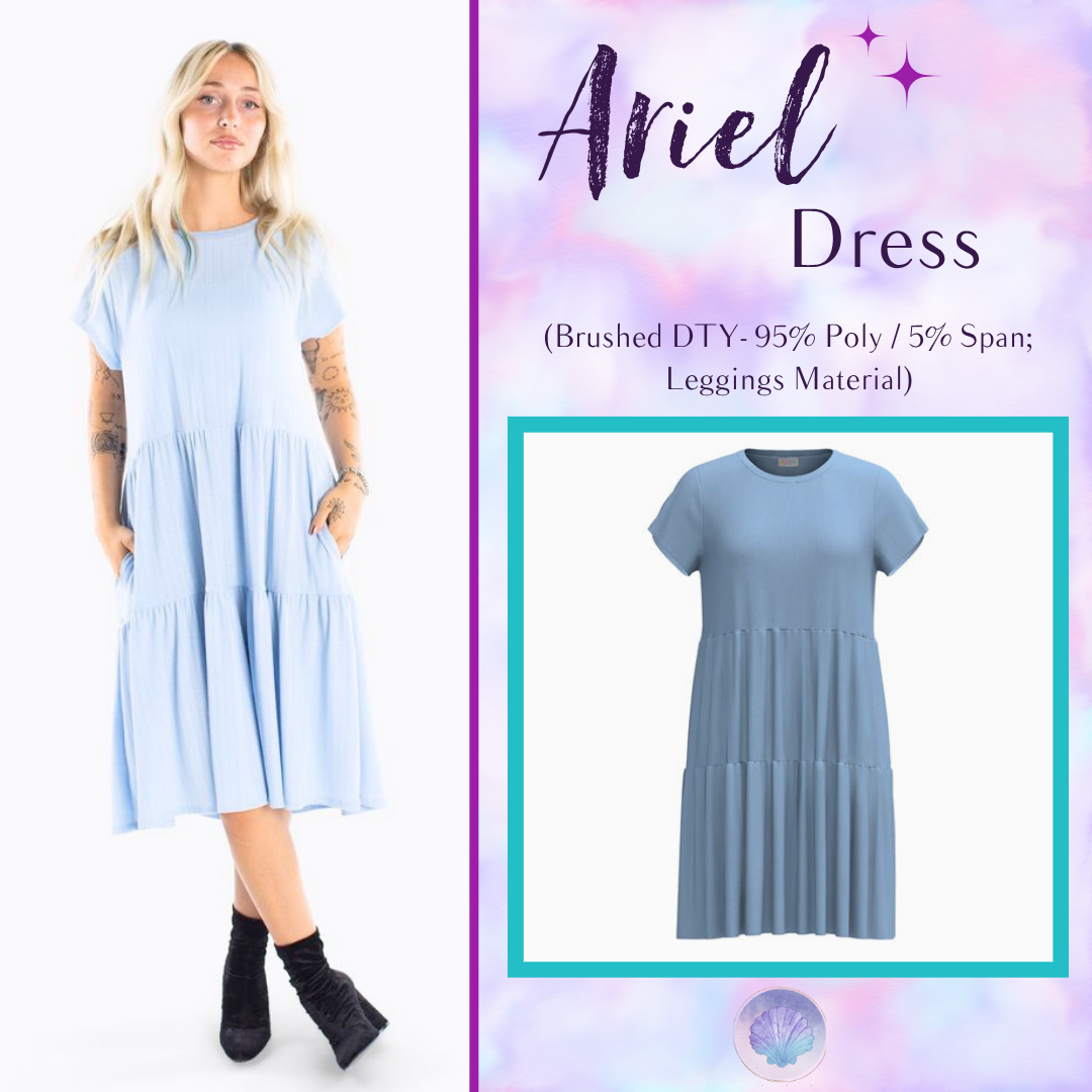 Woman wearing LuLaRoe Ariel Tiered Dress in Solid Powder Blue, a soft pastel blue tiered short dress with relaxed fit, flowy silhouette, and comfortable stretch fabric for spring and summer wear.