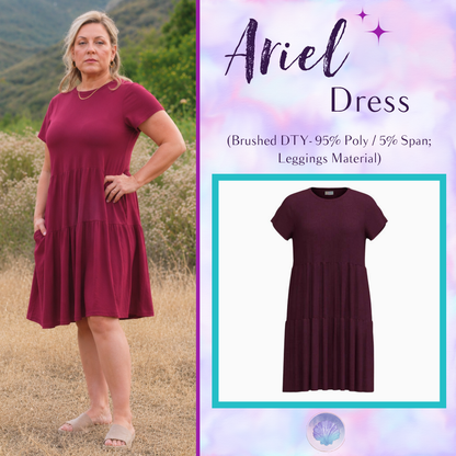Woman wearing LuLaRoe Ariel Tiered Dress in Solid Raspberry Wine, a rich berry red tiered short dress with relaxed fit, flowy silhouette, and soft stretch comfort for everyday and special occasion styling.