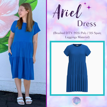 Woman wearing LuLaRoe Ariel Tiered Dress in Solid Sapphire Blue, a vibrant royal blue tiered short dress with relaxed fit, flowy silhouette, and soft stretch comfort for everyday and vacation wear.