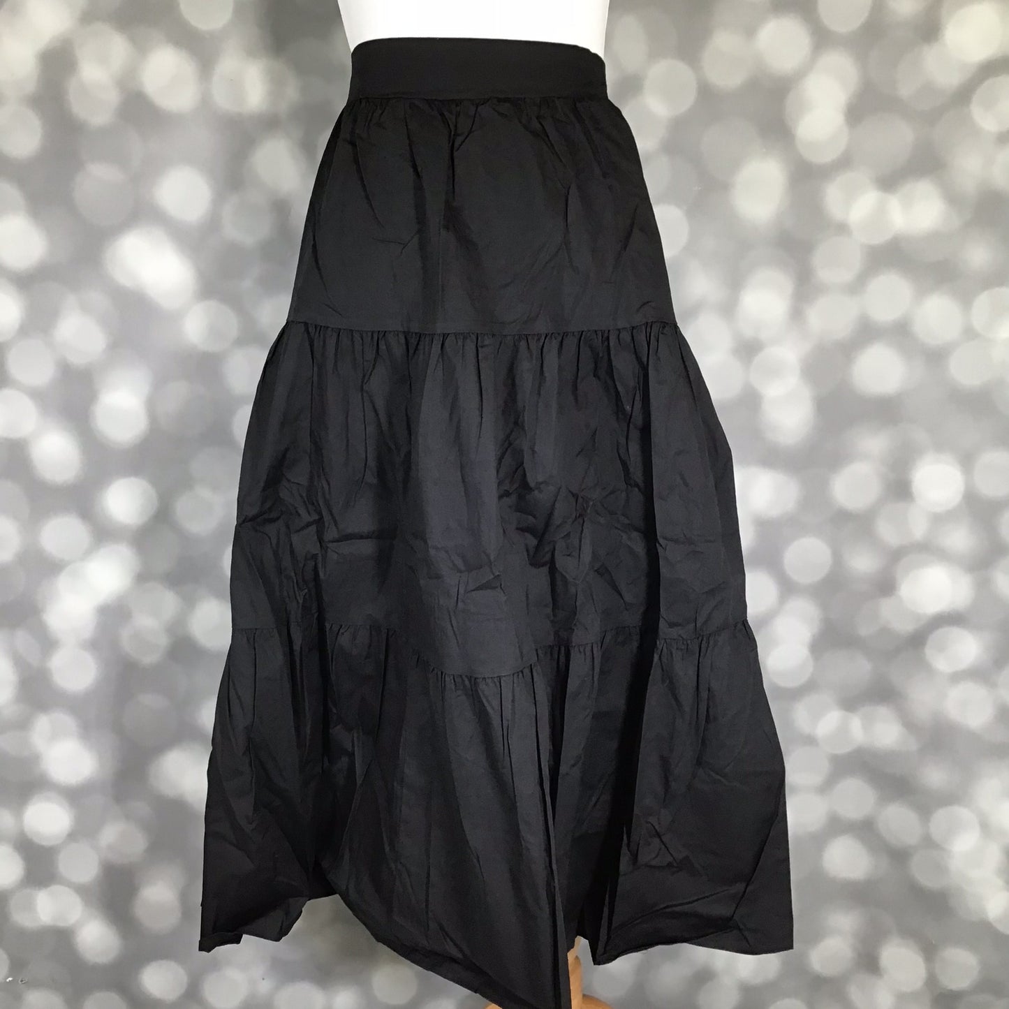 LuLaRoe Coletta Tiered Midi Skirt in Solid Black with a flowing tiered silhouette and comfortable waistband