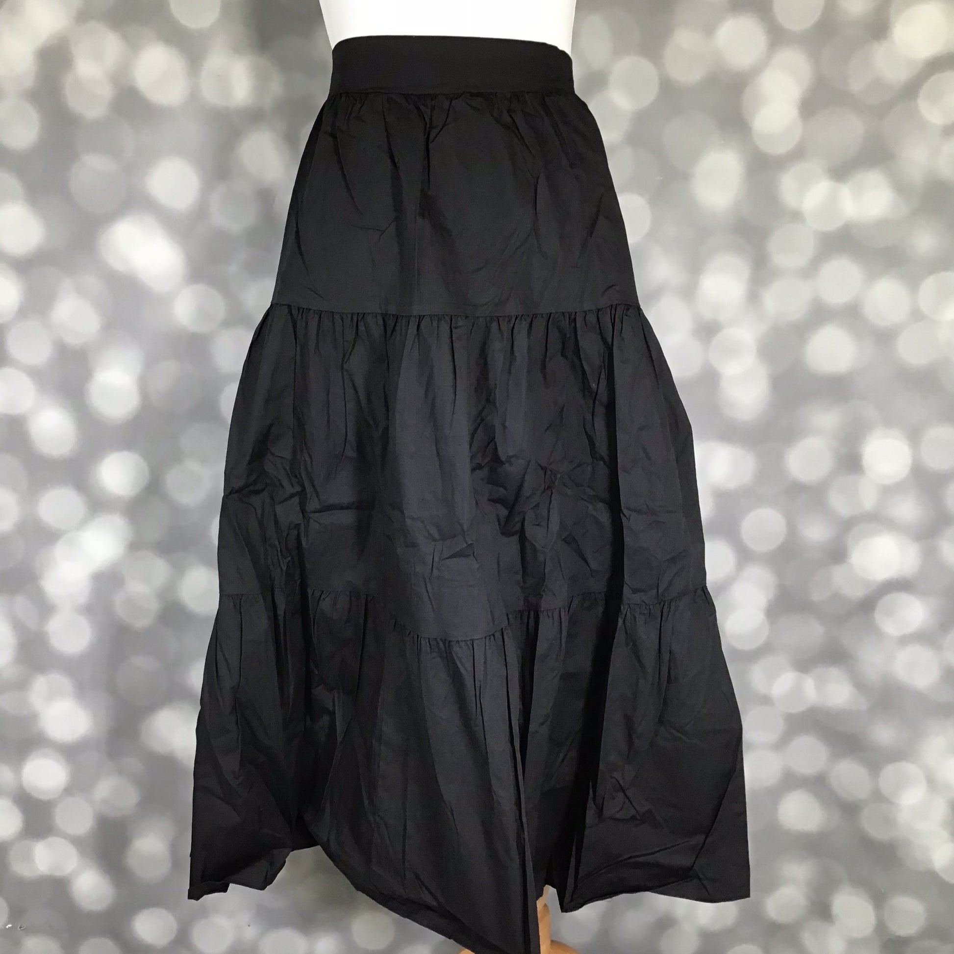 LuLaRoe Coletta Tiered Midi Skirt in Solid Black with a flowing tiered silhouette and comfortable waistband