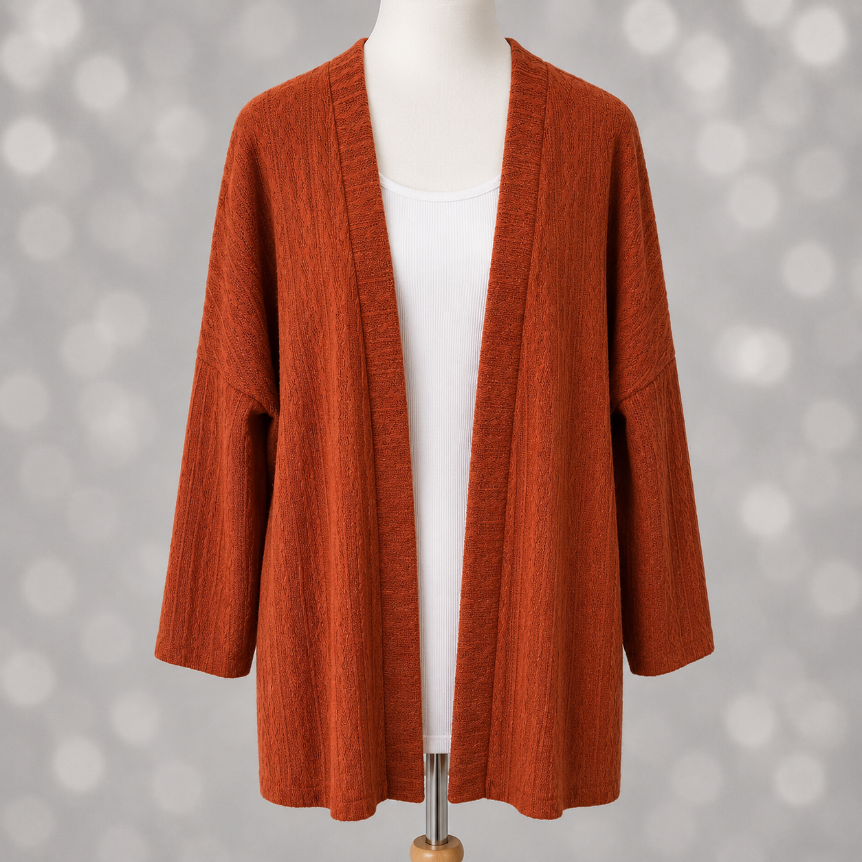 LuLaRoe Connie Lightweight Overlay in Solid Burnt Cinnamon featuring a lightweight cable knit texture, open front cardigan, relaxed fit, and long sleeves layered over a white ribbed tank.