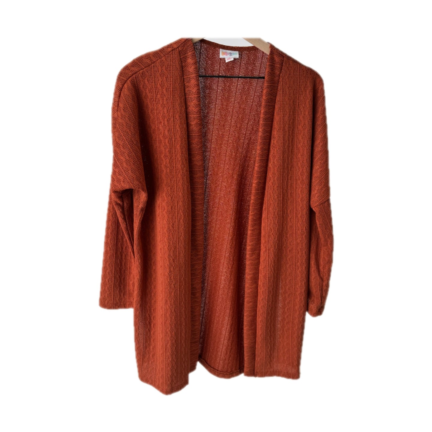 LuLaRoe Connie Lightweight Overlay in Solid Burnt Cinnamon featuring a lightweight cable knit texture, open front cardigan, relaxed fit, and long sleeves layered over a white ribbed tank.