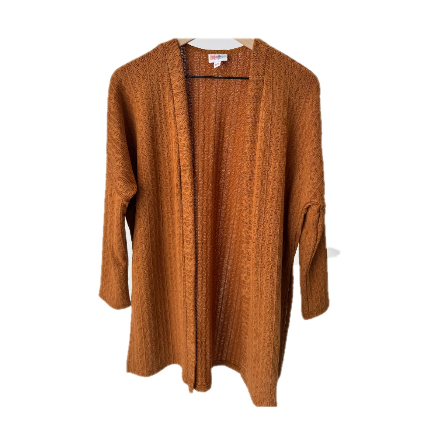 LuLaRoe Connie Lightweight Overlay in Solid Camel featuring a lightweight cable knit texture, open front cardigan, relaxed fit, and long sleeves layered over a white ribbed tank.