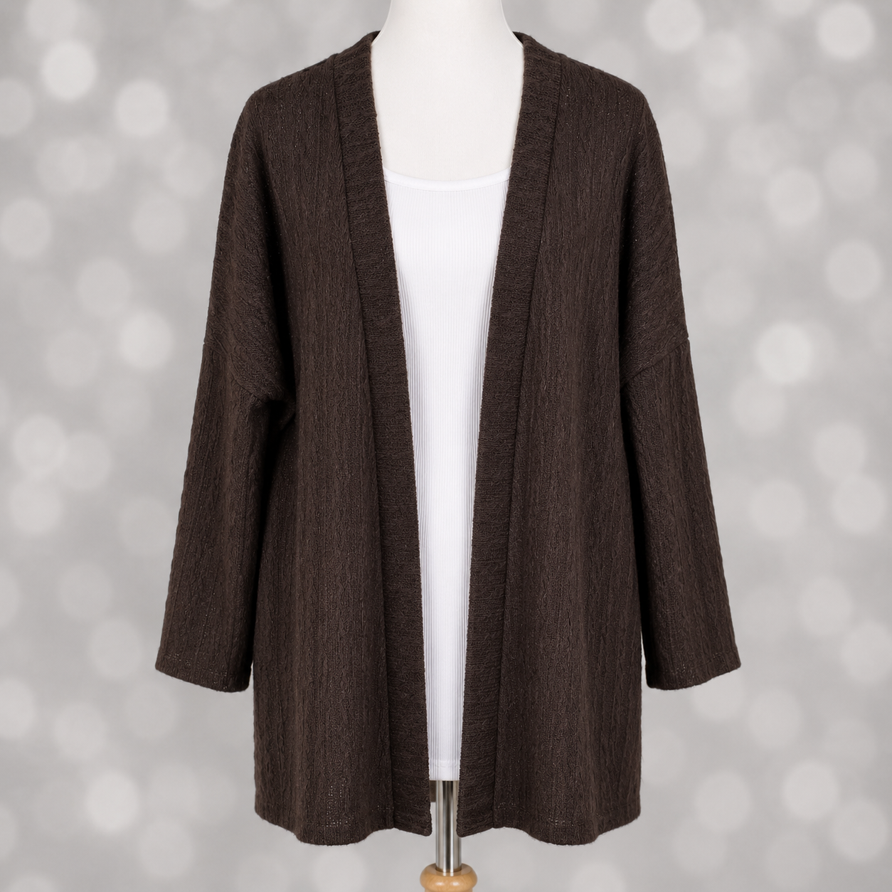 LuLaRoe Connie Lightweight Overlay in Solid Chocolate Brown featuring a lightweight cable knit texture, open front cardigan, relaxed fit, and long sleeves layered over a white ribbed tank.