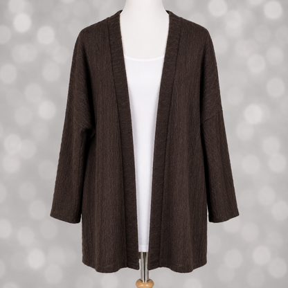 LuLaRoe Connie Lightweight Overlay in Solid Chocolate Brown featuring a lightweight cable knit texture, open front cardigan, relaxed fit, and long sleeves layered over a white ribbed tank.
