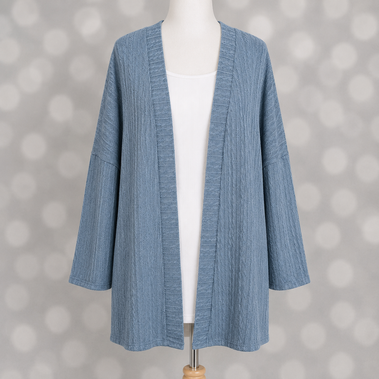 LuLaRoe Connie Lightweight Overlay in Solid Denim Blue featuring a lightweight cable knit texture, open front cardigan, relaxed fit, and long sleeves layered over a white ribbed tank.