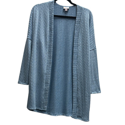 LuLaRoe Connie Lightweight Overlay in Solid Denim Blue featuring a lightweight cable knit texture, open front cardigan, relaxed fit, and long sleeves layered over a white ribbed tank.